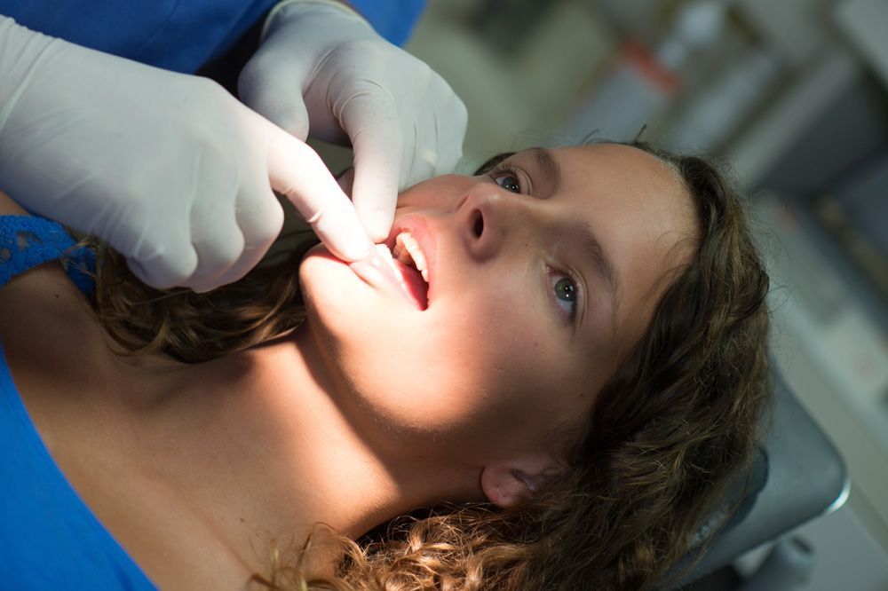 Periodontist examining a patient's gums.